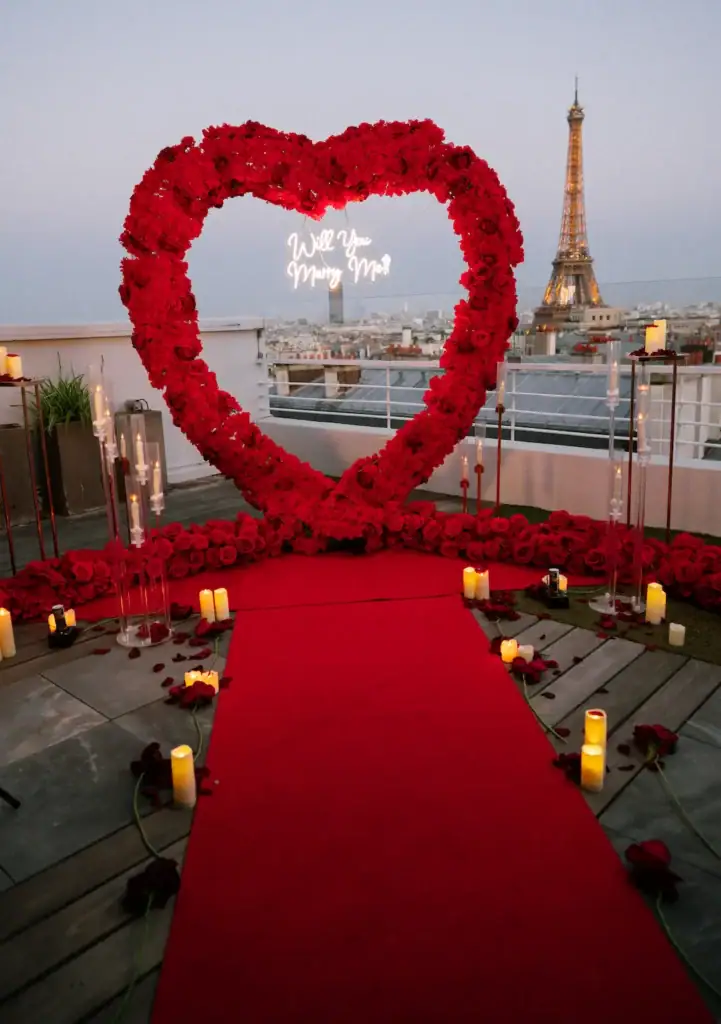 Romantic Paris proposal setup with Eiffel Tower view and heart-shaped floral arch.