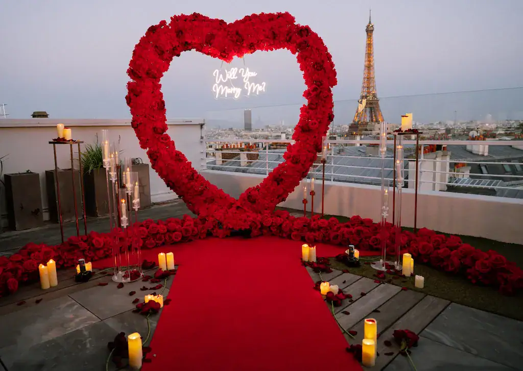 Heart-shaped floral arch with Eiffel Tower view for proposal.